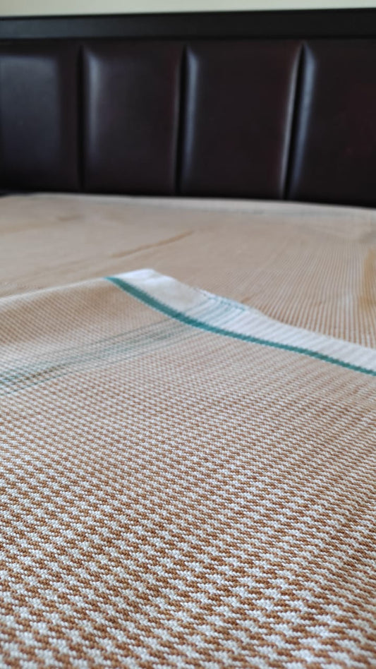 Khaki cotton khes handwoven double‑cloth throw in Majnu pattern, spread out to show texture and fringed edges.