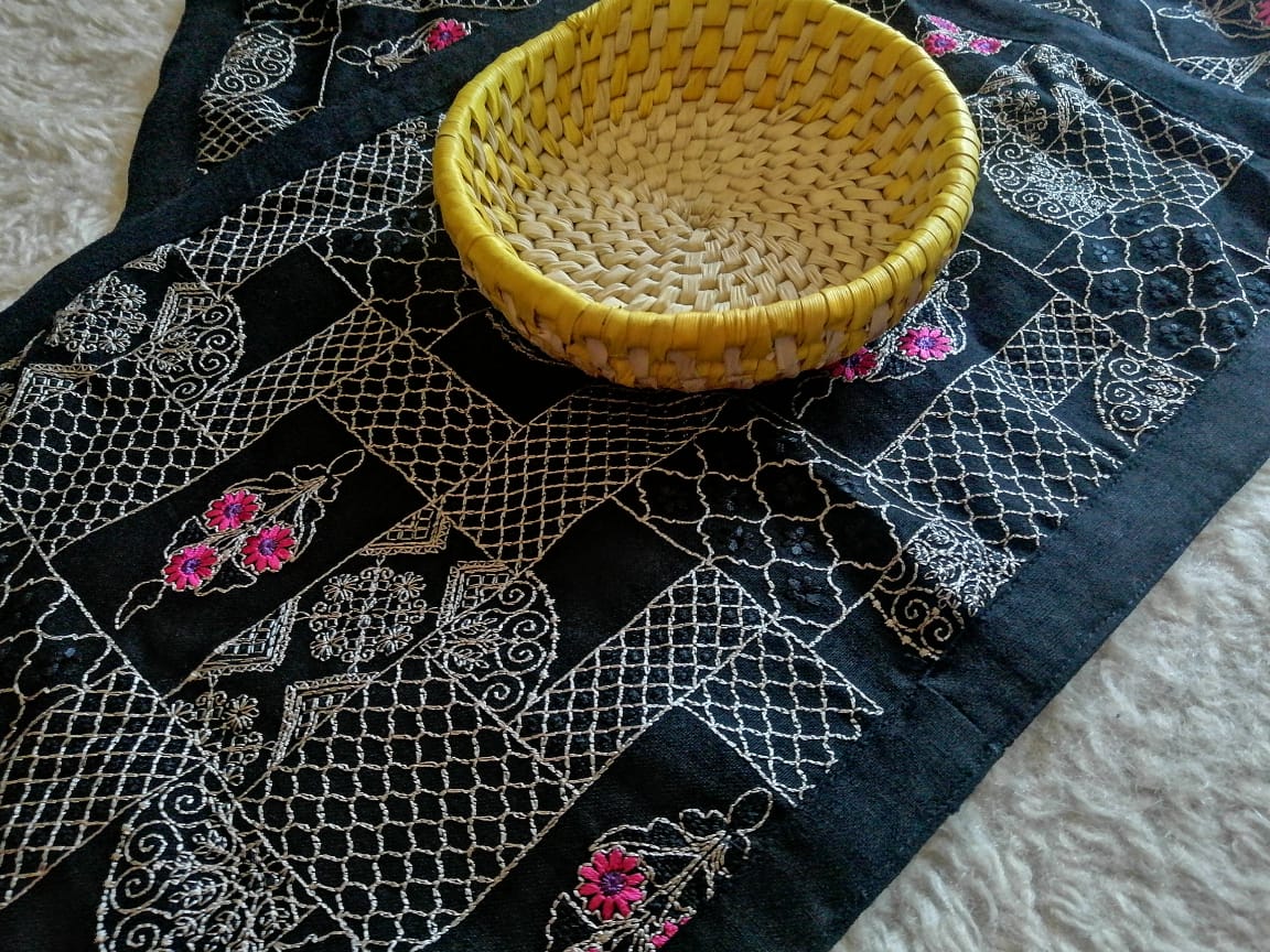 Eco-friendly handloom table mats in a traditional weave, styled with ceramic tableware