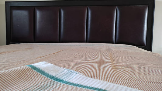 Khaki cotton khes handwoven double‑cloth throw in Majnu pattern, spread out to show texture and fringed edges.