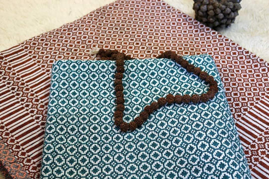 “Close‑up of teal Cotton Majnu Khes showing geometric double‑cloth pattern and texture.”