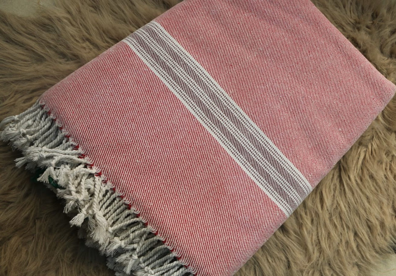 Pink towel with white stripes on a brown textured surface