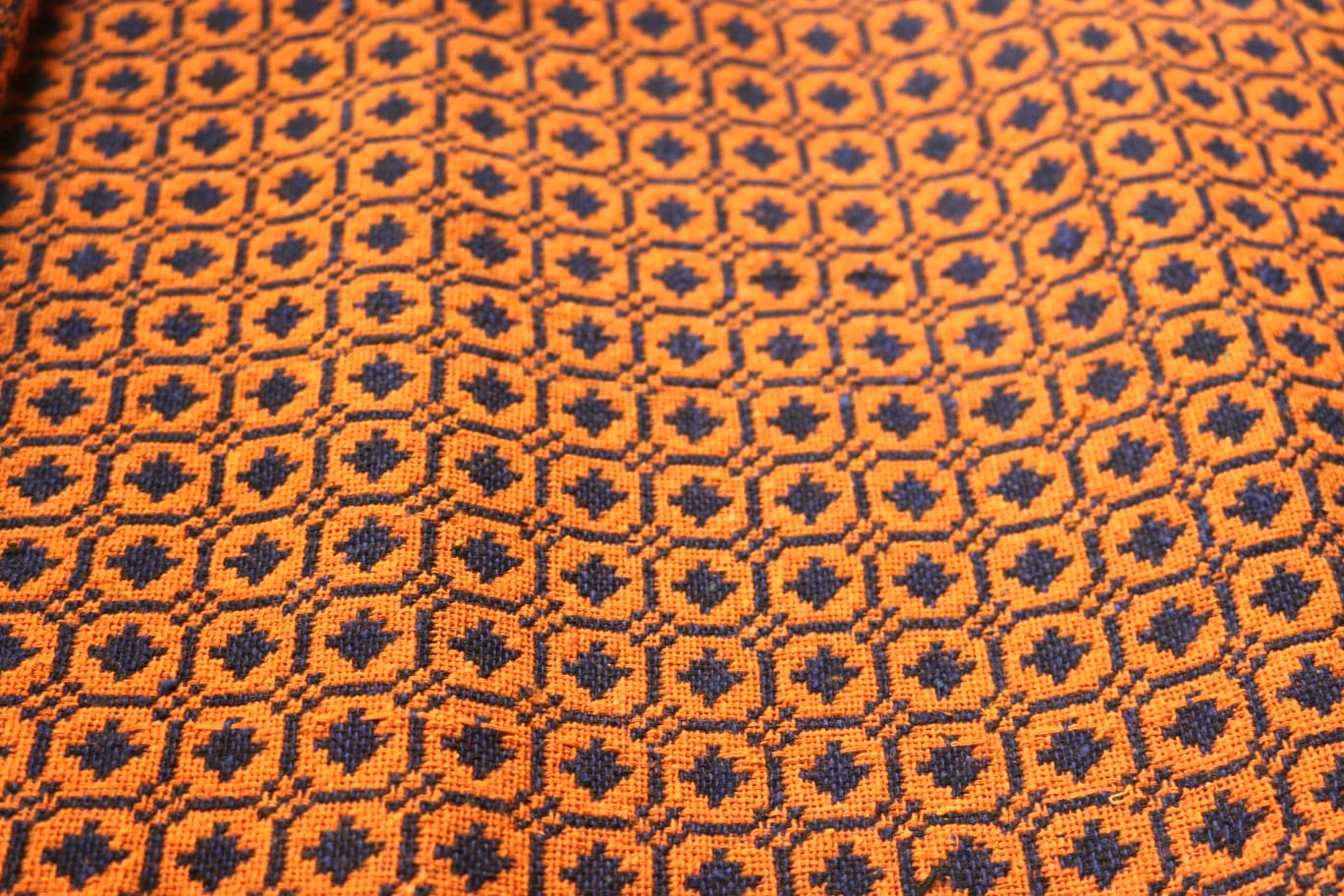 Close-up of orange and black geometric patterned fabric