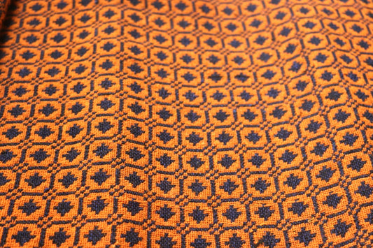 Close-up of orange and black geometric patterned fabric