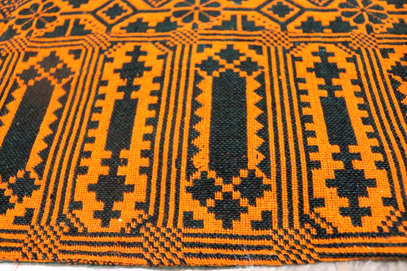 Close-up of a patterned orange and green khes