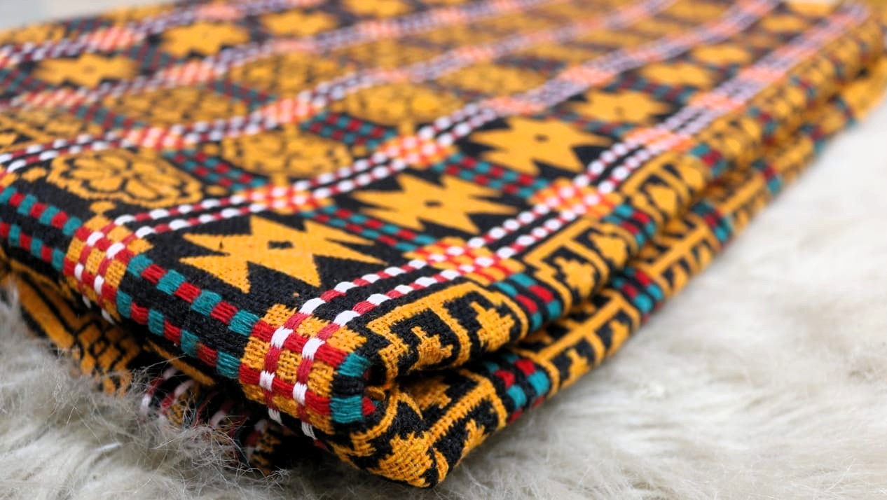 Colorful patterned fabric on a textured surface