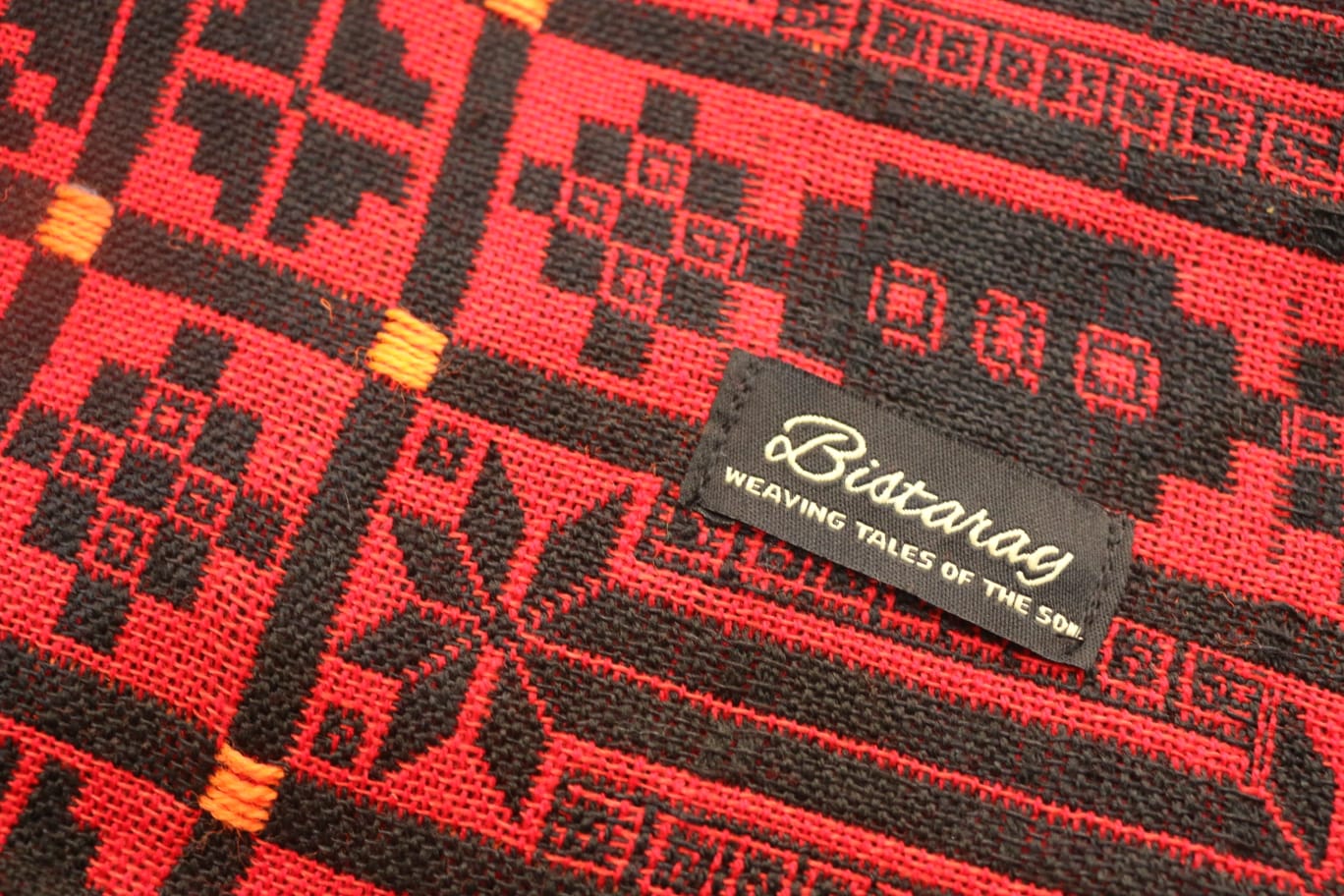 Close-up of a red and black woven fabric with a Biscaray label.