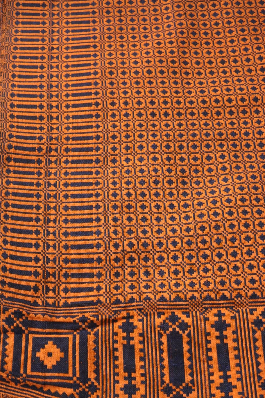Close-up of a patterned fabric with orange and black colors